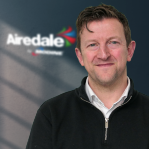 Richard Burcher standing in front of the Airedale logo