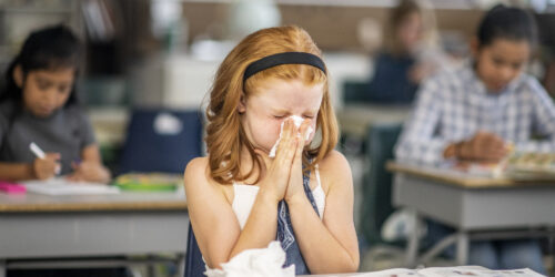 Child Sneezing in a classroom