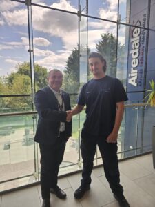 Airedale by Modine's Vice President Adrian Trevelyan shaking hands with Lab Engineer George Hardesty